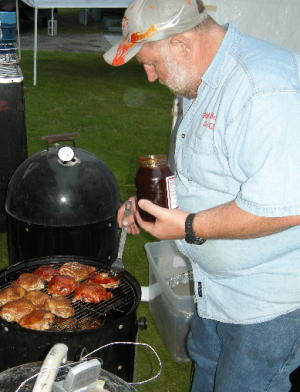 Big Daddy Harold Groetsema puts the finishing touches to BBQ chicken